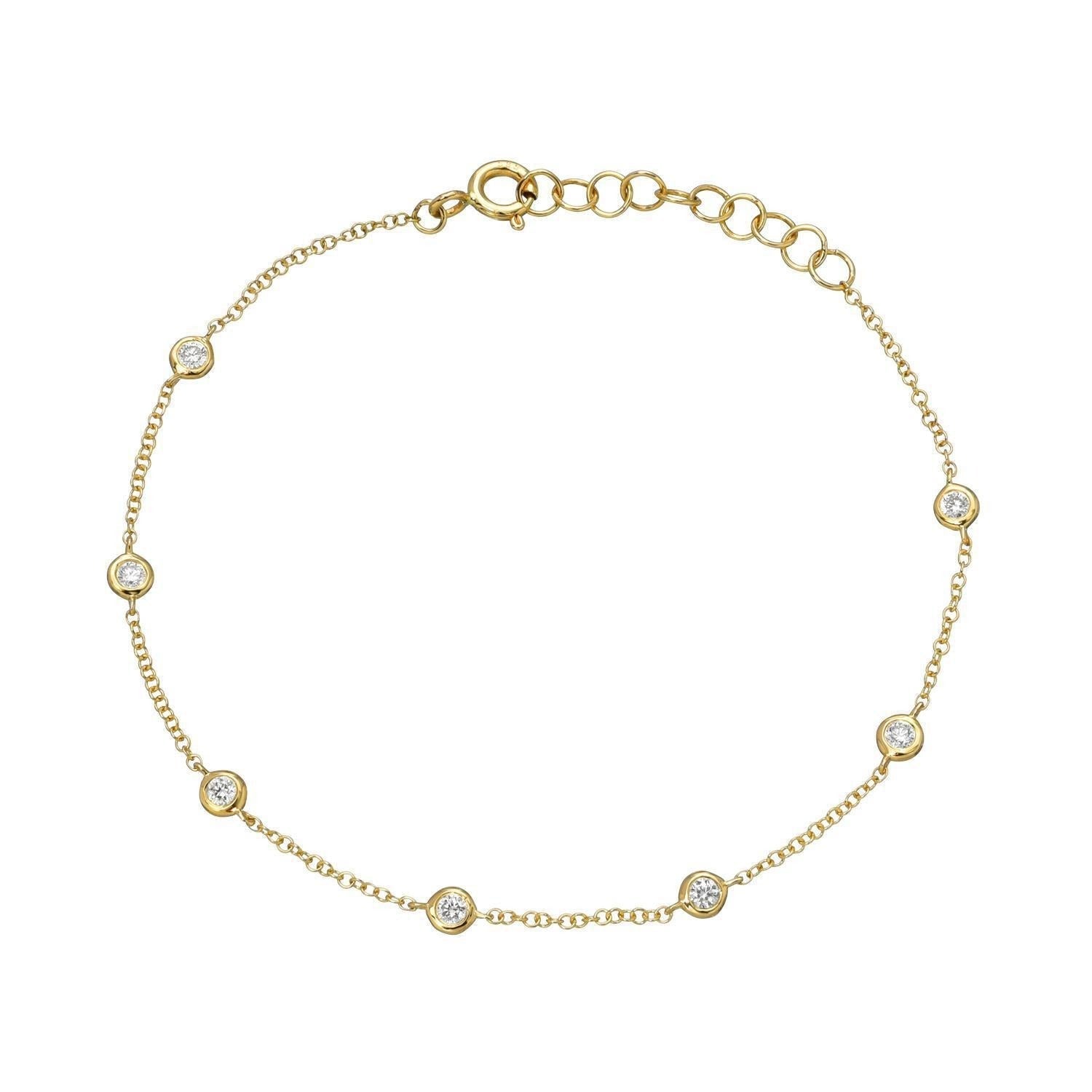 Bezel Diamond Station Bracelet: A delicate gold chain bracelet featuring seven evenly spaced round diamonds, each set in a small bezel, complete with an adjustable clasp and extension links for the perfect fit—a timeless piece from Janet Heller Fine Jewelry.