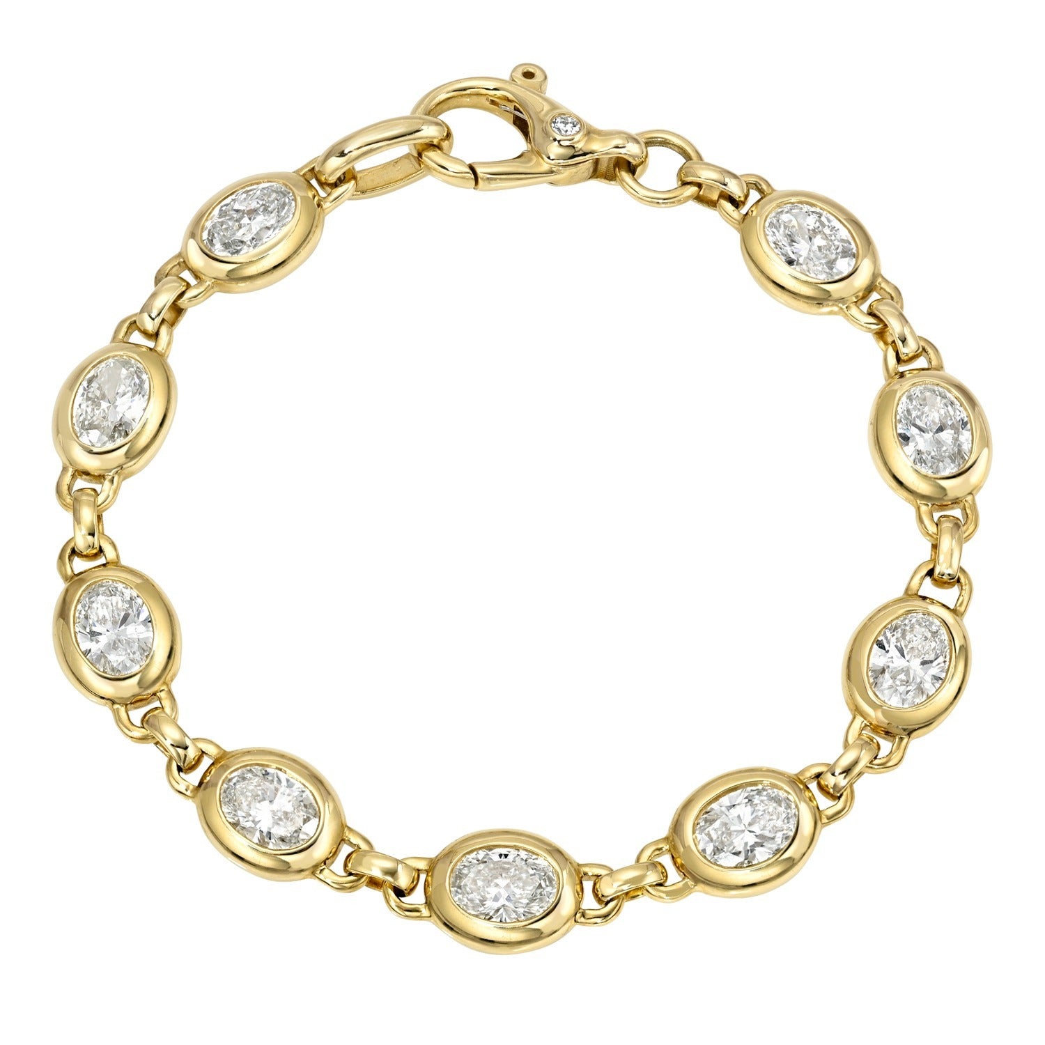Introducing the Bezel Set Lab Oval Tennis Bracelet: a stunning gold bracelet adorned with oval-shaped lab-created gemstones, each elegantly set in individual bezel settings and linked together with a secure lobster clasp closure—making it an exquisite addition to any fine jewelry collection.