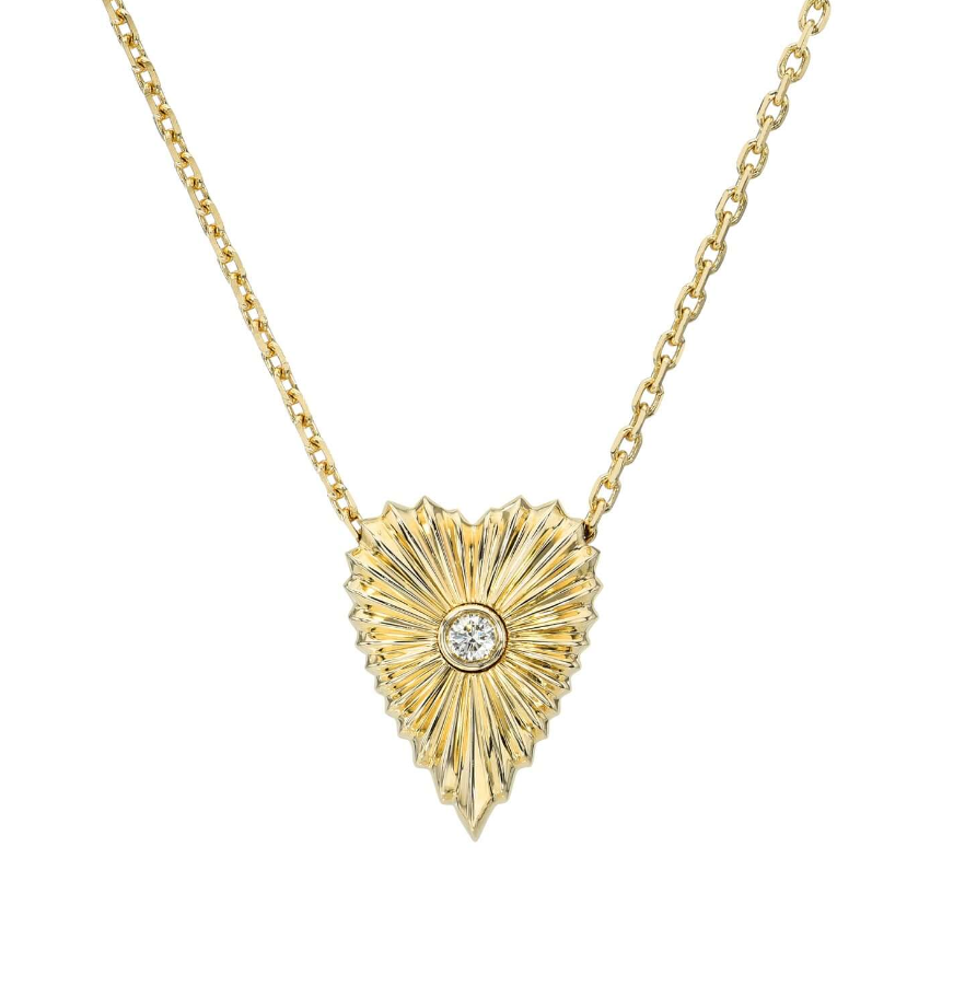 The Diamond Small Elongated Heart Ribbed Necklace features a textured, elongated heart-shaped pendant with a central diamond on a delicate gold chain. For custom pieces or inquiries, explore Janet Heller Fine Jewelry.