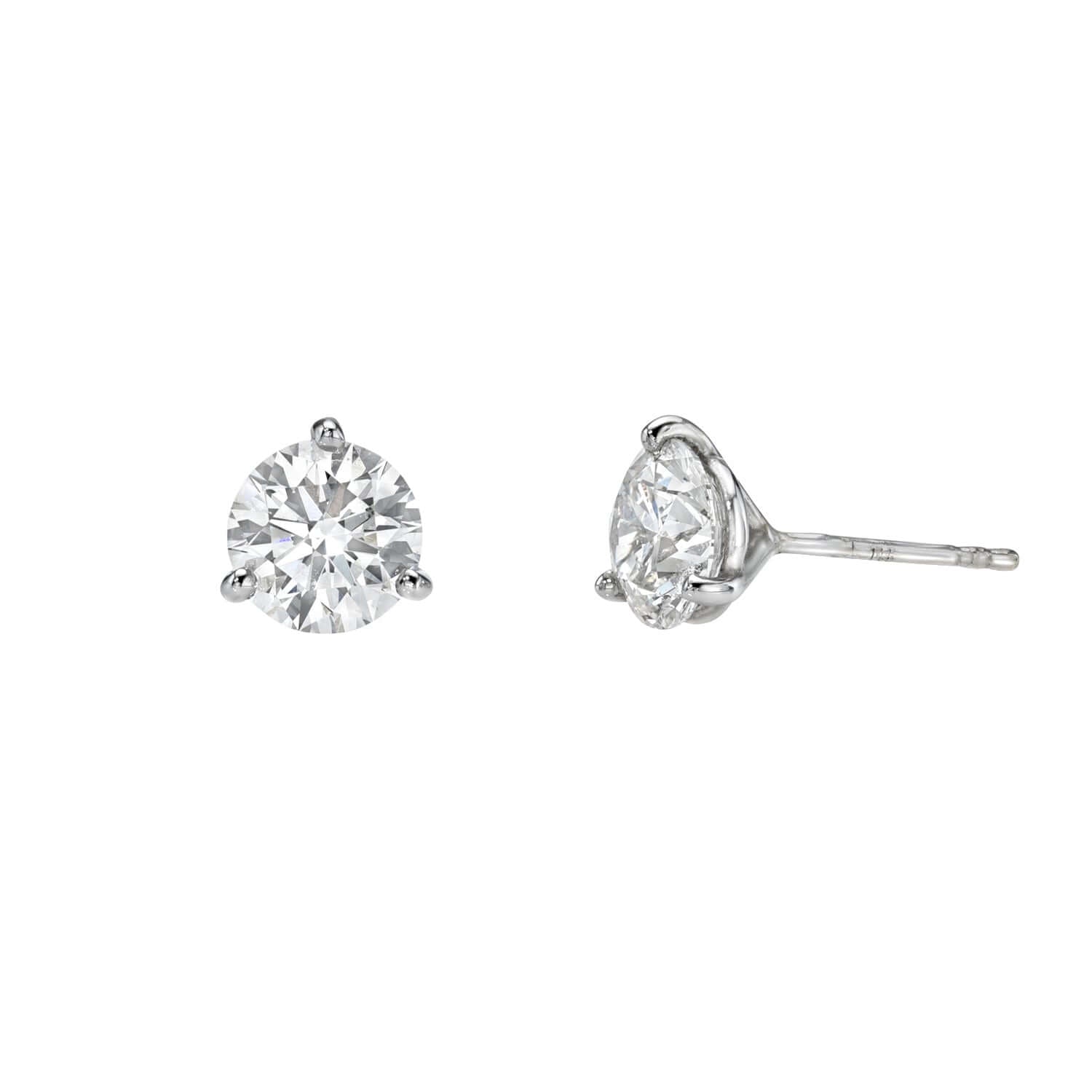 A pair of Lab Diamond Studs featuring round lab-grown diamonds in three-prong white metal settings, shown from the front and side on a white background—an elegant example of Janet Heller fine jewelry. For custom jewelry or inquiries, please contact us.