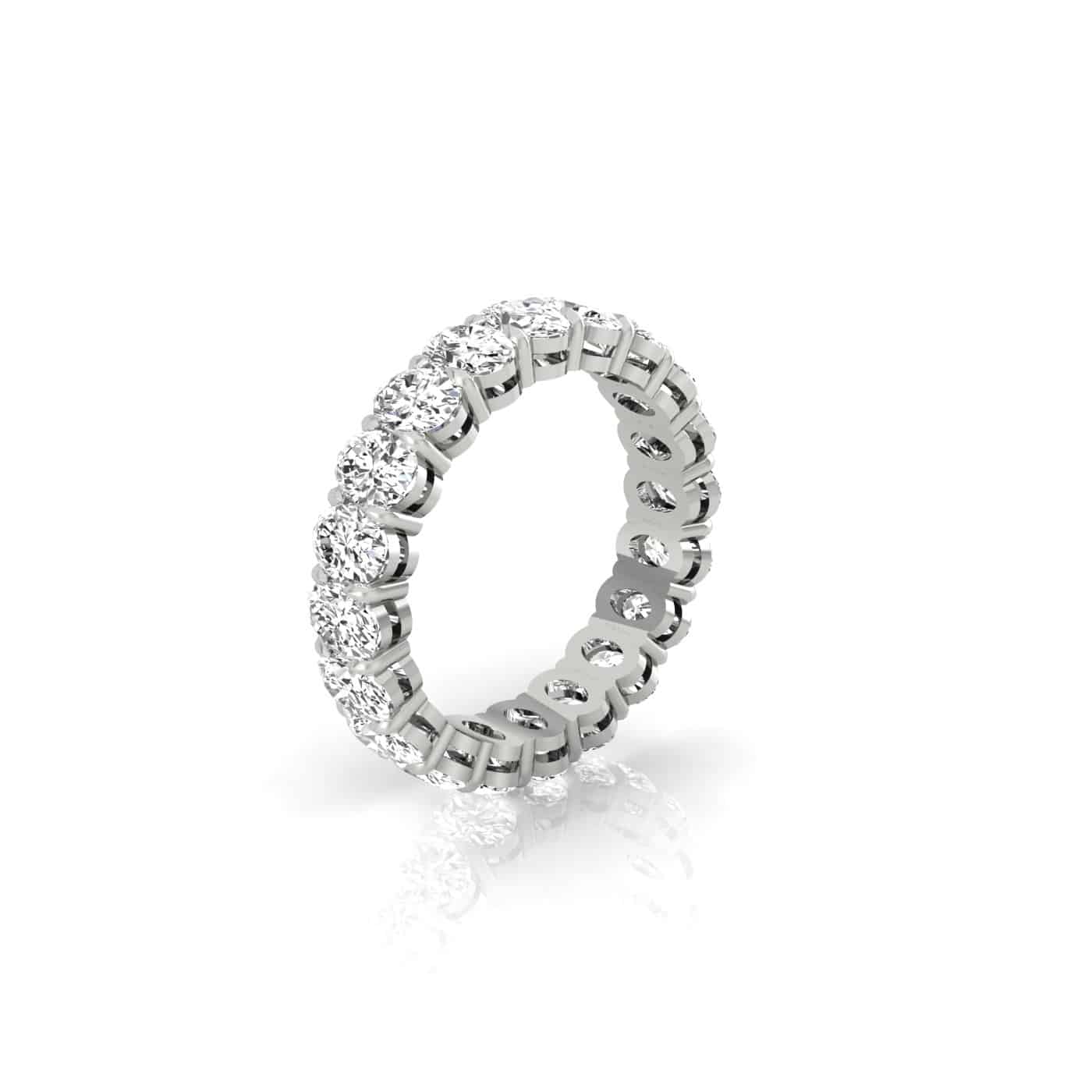 The Test - Full Diamond Eternity Ring is an exquisite 18KT white gold band, featuring round-cut F color VS clarity diamonds set all around and displayed upright on a white reflective surface—designed to dazzle from every angle.