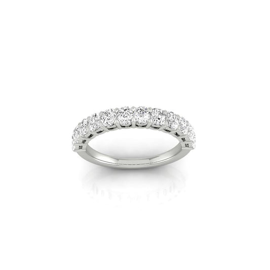 The Half Diamond Eternity Ring is crafted from white 18KT gold, featuring a row of evenly spaced round diamonds with VS Clarity set along the top half. Its smooth, reflective band highlights the elegant and classic design against a plain white background.