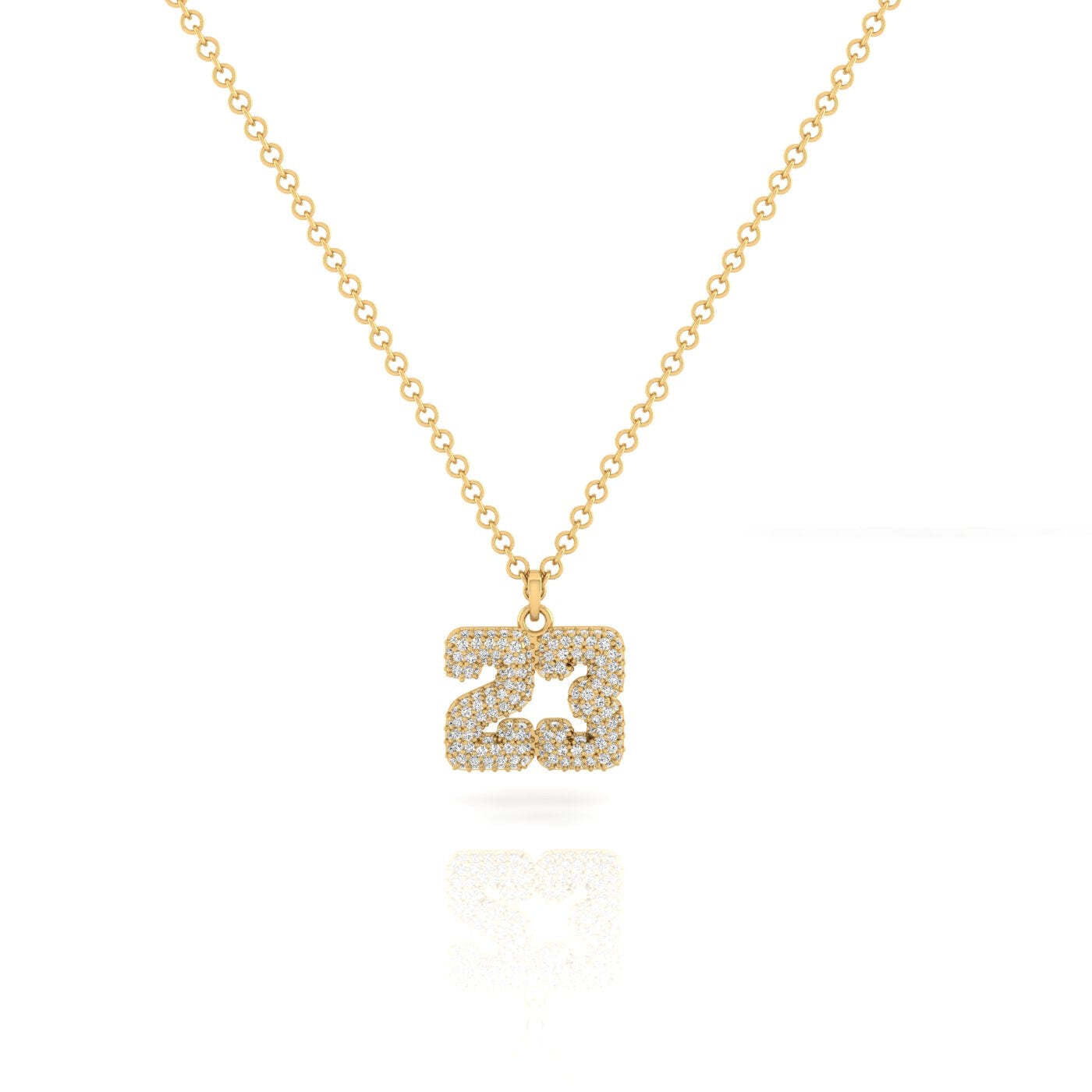Introducing the Varsity Diamond Number Necklace, a personalized jewelry piece crafted in 14KT Yellow Gold. This necklace features a pendant shaped as the number 23, adorned with shimmering clear gemstones, and is presented on a clean white background.