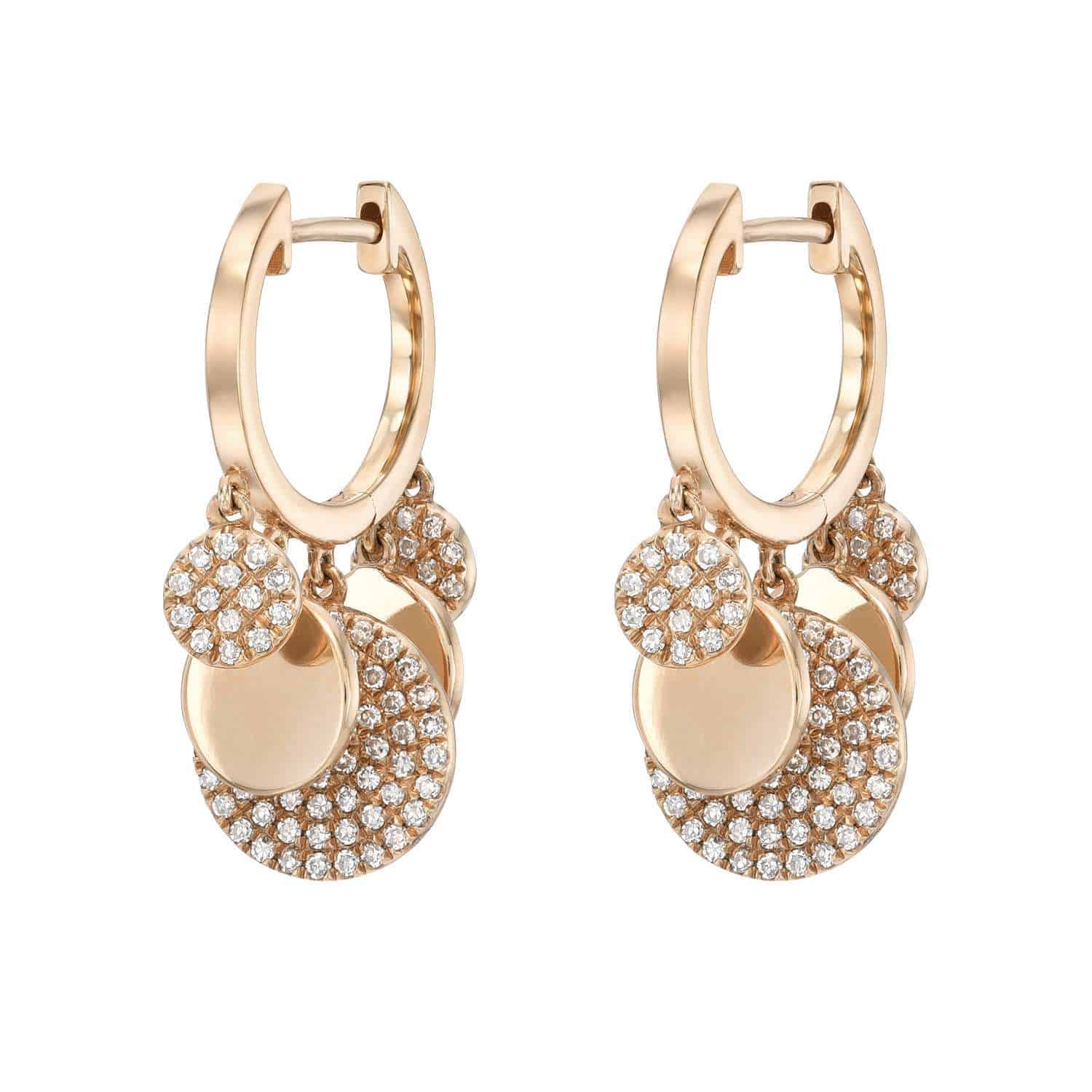 The Alternating Diamond Disc Huggies feature gold hoops adorned with three dangling circular charms on each earring—two are encrusted with sparkling diamonds, while the third is a polished gold disc—making them a striking piece from Janet Heller Fine Jewelry. For custom orders or jewelry inquiries, please contact us for more information.