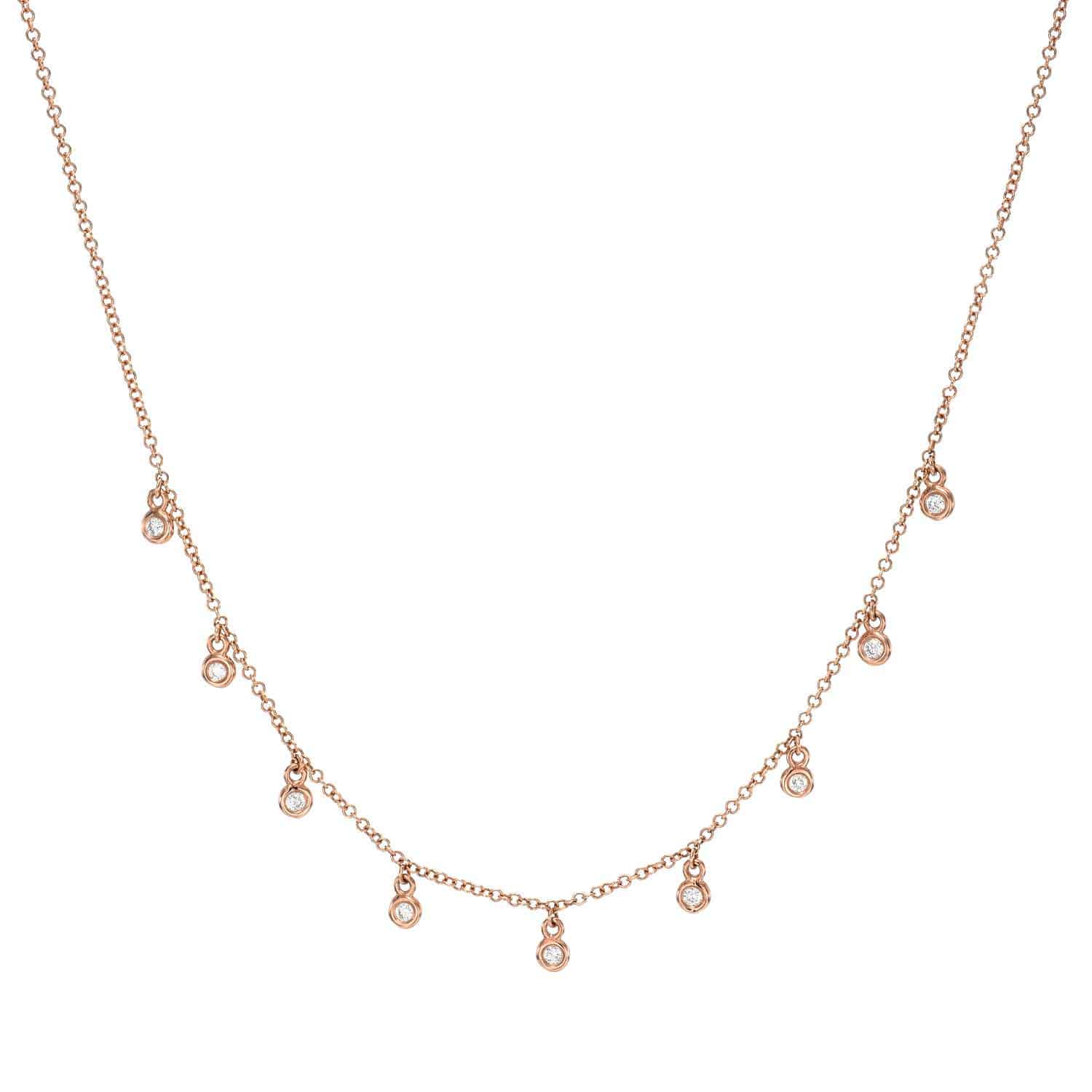 Bezel Diamond Drop Necklace – A delicate gold chain adorned with nine evenly spaced small round bezel-set diamond pendants along the front, this timeless piece from Janet Heller Fine Jewelry is priced at $565. For custom jewelry requests or inquiries, please contact us.