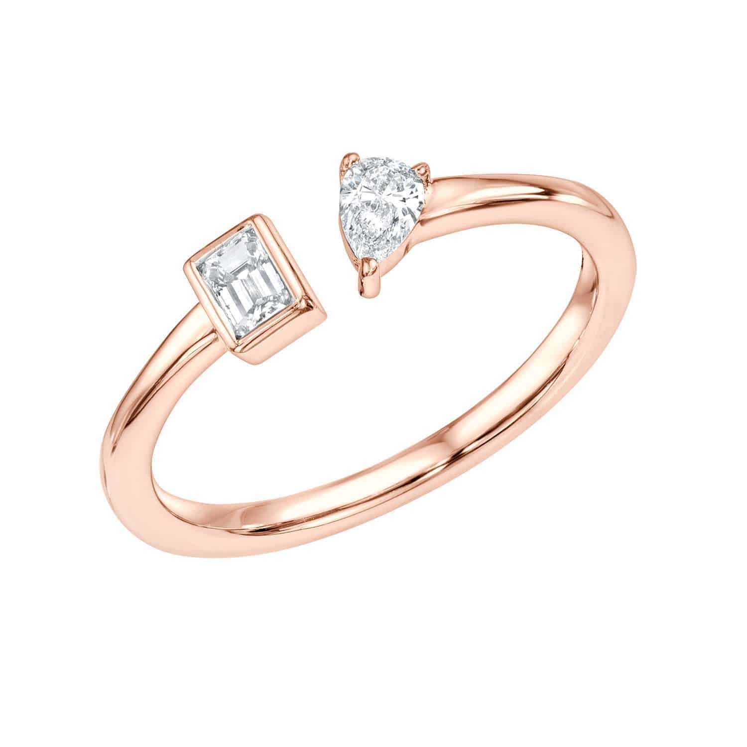 Introducing the Diamond Toi Et Moi Ring: a stunning rose gold open band ring showcasing a rectangular baguette-cut diamond on one end and a pear-shaped diamond on the other. Available in a variety of ring sizes. For custom options or to preorder the Diamond Toi Et Moi Ring, please contact us.