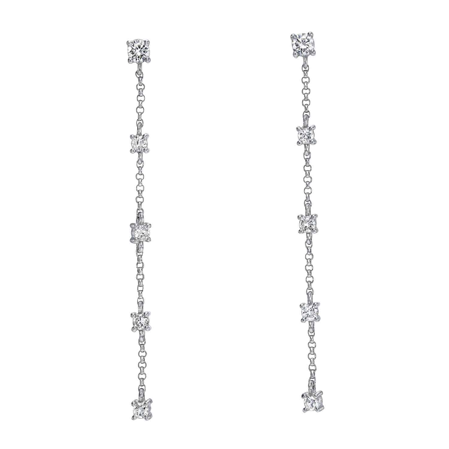 Introducing the 5 Drop Diamond Finley Earrings—an exquisite pair of long, dangling silver earrings, each adorned with five evenly spaced, sparkling round diamonds delicately set along a fine chain. Elevate your fine jewelry collection with the radiant elegance of these stunning earrings. Price: $945.00.