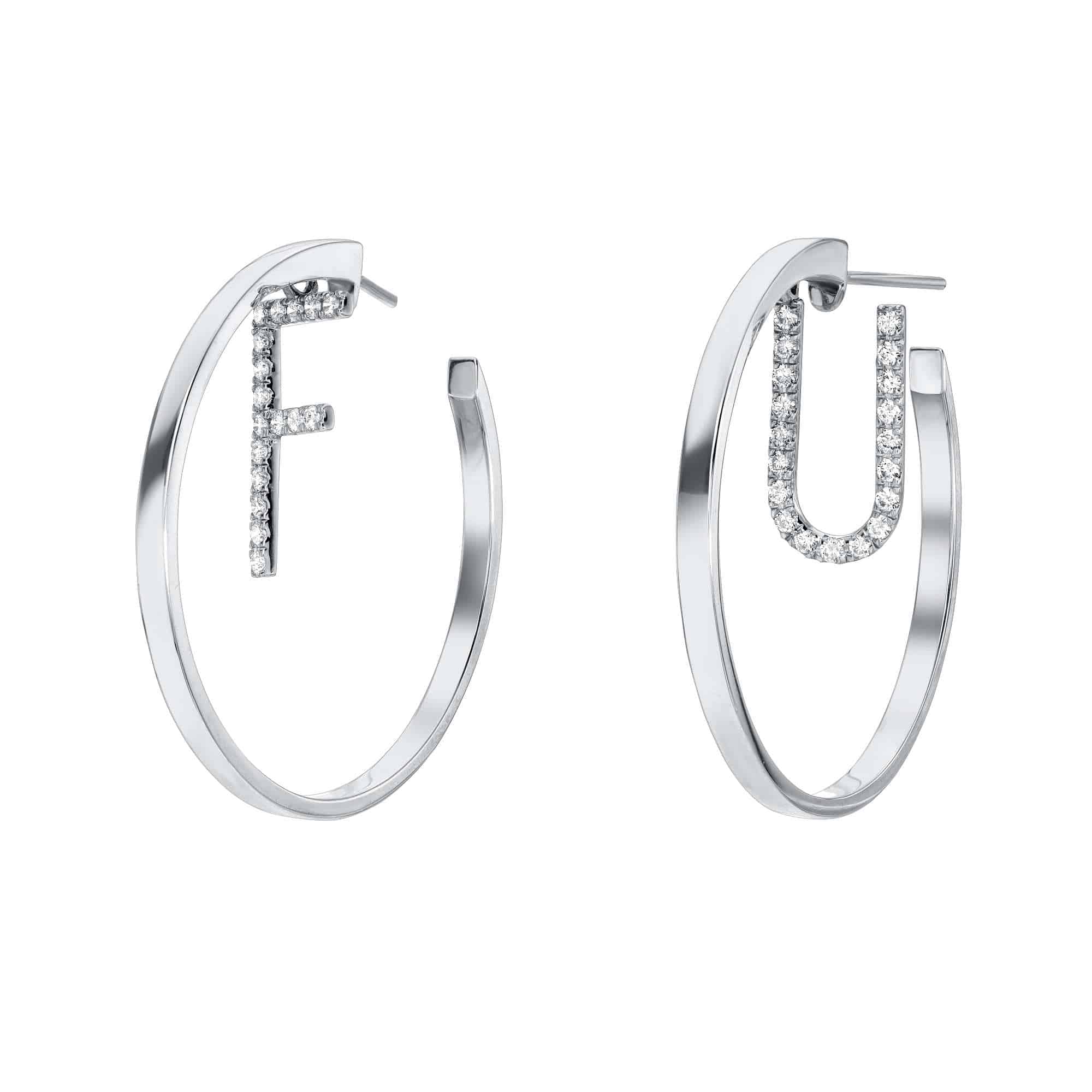 Two Diamond Letter Maeve Earrings in silver with clear crystals; one earring features the letter F in the center, and the other showcases the letter U. Both letters are crafted from small, sparkling stones. Custom letters of these Diamond Letter Maeve Earrings are available for preorder.
