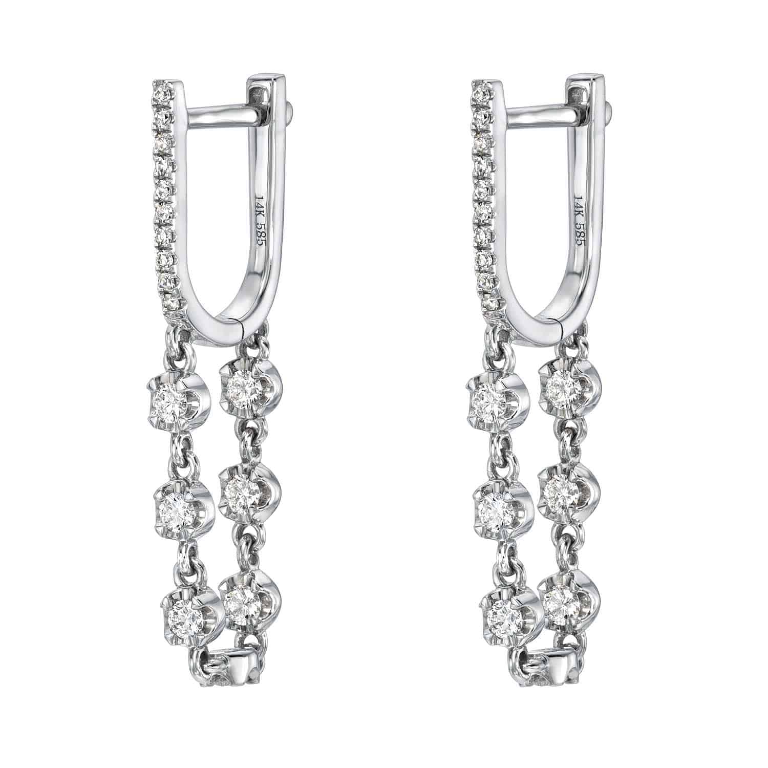 Introducing the Diamond Loop Huggies by Janet Heller Fine Jewelry—these stunning silver earrings feature a hinged hoop design, each adorned with two dangling chains embellished with round, sparkling clear gemstones. Additional gems line the front edge for extra brilliance, making these earrings a perfect choice for those who appreciate custom jewelry with sophisticated, elegant details.