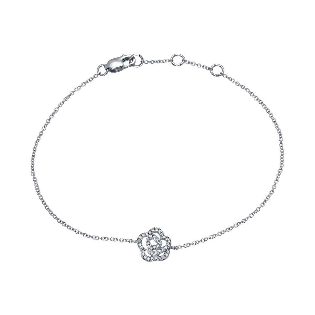 The Diamond Rose Bracelet is a delicate silver chain adorned with a small, rose-shaped charm encrusted with clear gemstones at the center. It features a lobster clasp and multiple rings for adjustable sizing.