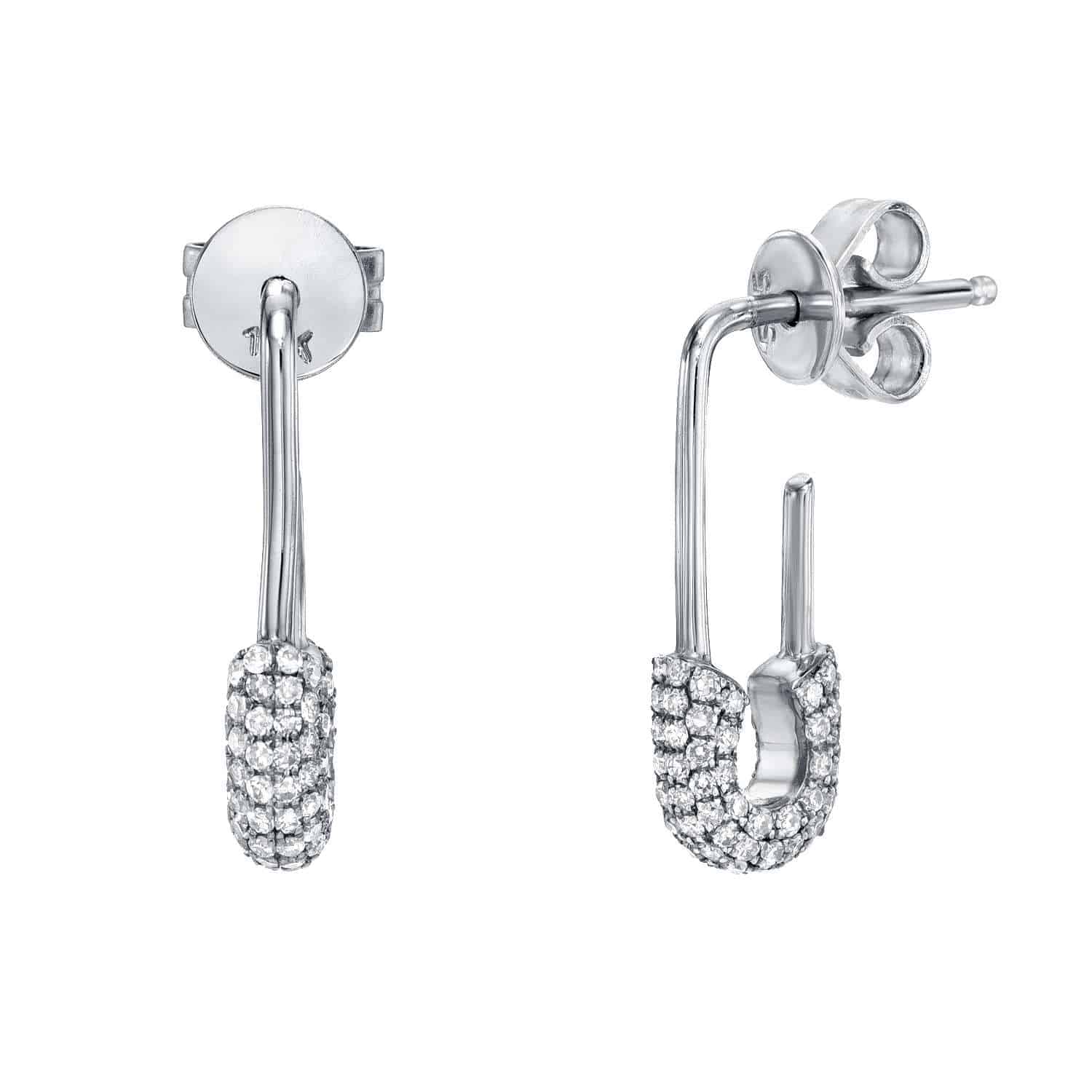 A pair of Diamond Safety Pin Earrings from Janet Heller Fine Jewelry, expertly crafted in silver and designed in the shape of safety pins, featuring a lower curved half encrusted with sparkling clear diamonds. These fine jewelry pieces are shown from both the front and side views. Price: $860.00.