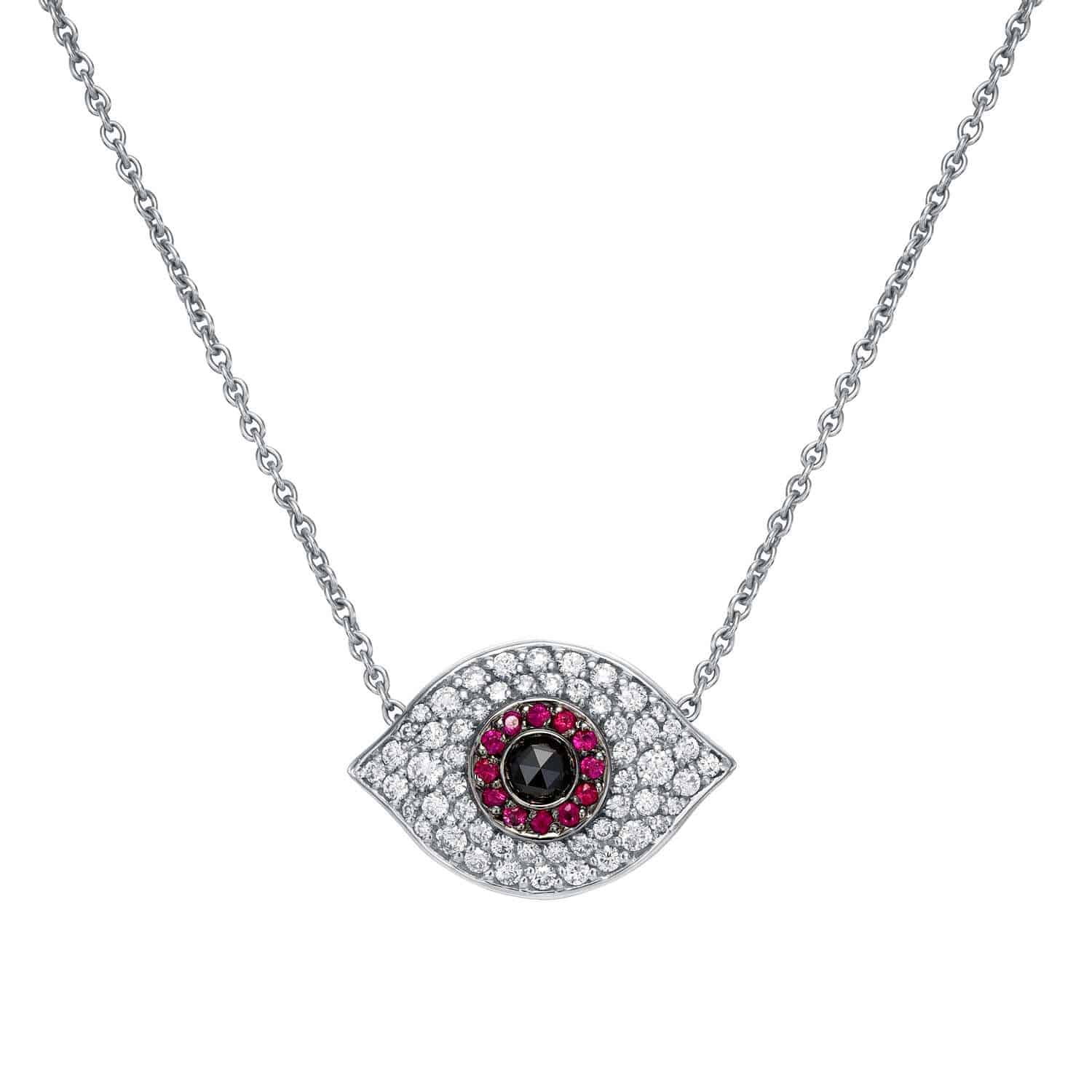 The Ruby & Diamond Evil Eye Necklace features an eye-shaped silver pendant adorned with sparkling white diamonds, a halo of vibrant rubies, and a central black stone, evoking a classic evil eye motif.