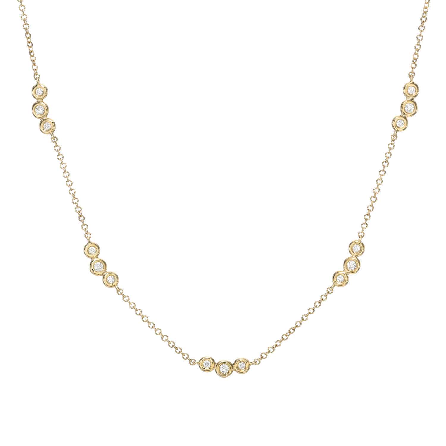 Discover the Bezel Diamond Trio Station Necklace—a delicate gold necklace featuring small round diamonds set in trios along the chain, evenly spaced to create a subtle, elegant pattern. This timeless piece from Janet Heller Fine Jewelry is perfect for any occasion. For jewelry inquiries or to explore custom jewelry options, please contact us.