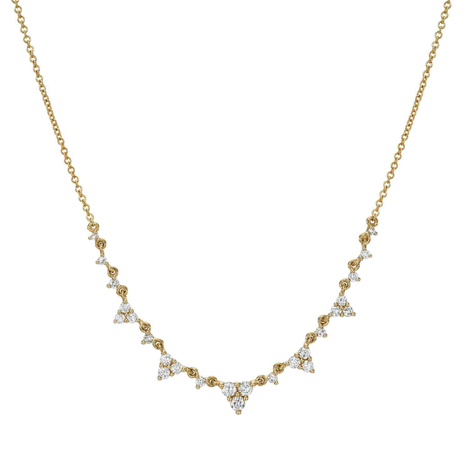 Introducing the Diamond Paisley Necklace: a gold chain necklace adorned with evenly spaced, delicate clusters of triangular diamonds along the front.