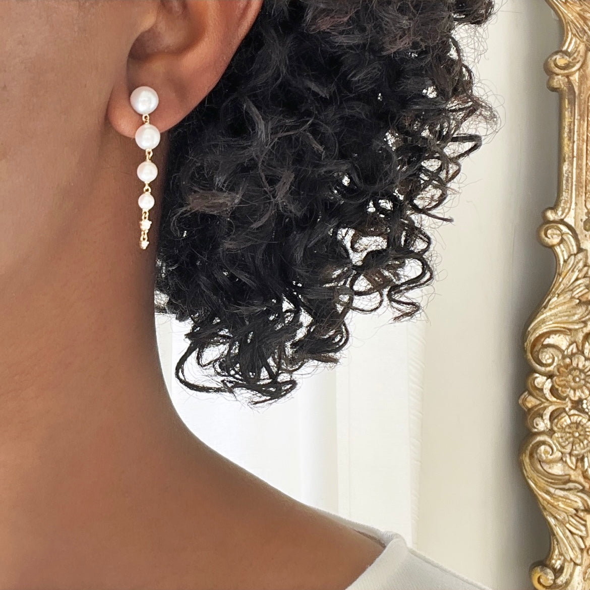 The Diamond & Pearl Drop Earrings from Janet Heller Fine Jewelry are crafted in 14KT gold.  These dangle earrings showcase four linked pearls, finished with a pair of small diamonds that complete the design.  The earrings can be worn alone or layered along the ear with other earrings