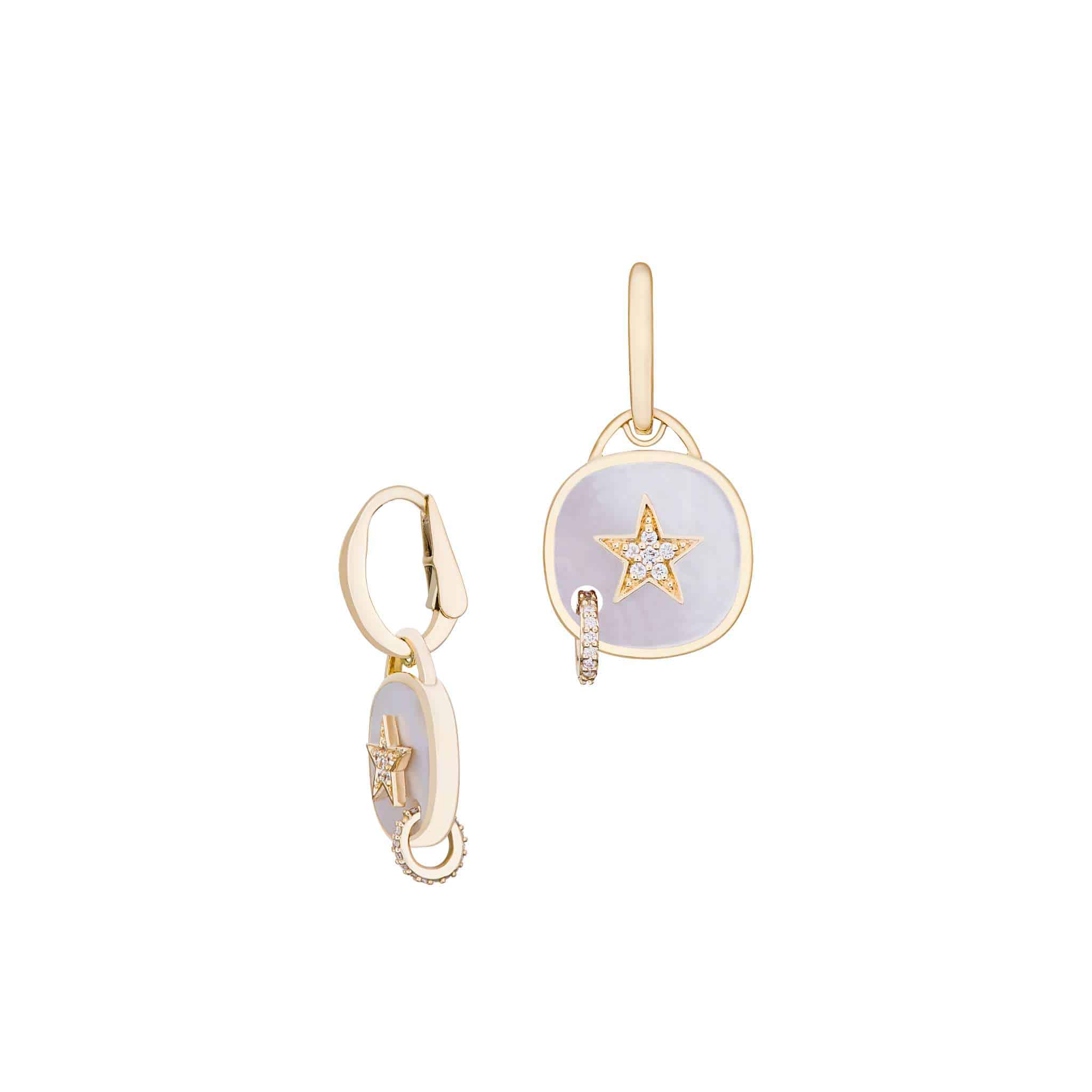 White Mother of Pearl Piercing Star Earrings featuring round, light purple pendants with a gold star design and small embedded diamonds. One earring is open to reveal the clasp, and both are displayed on a white background.