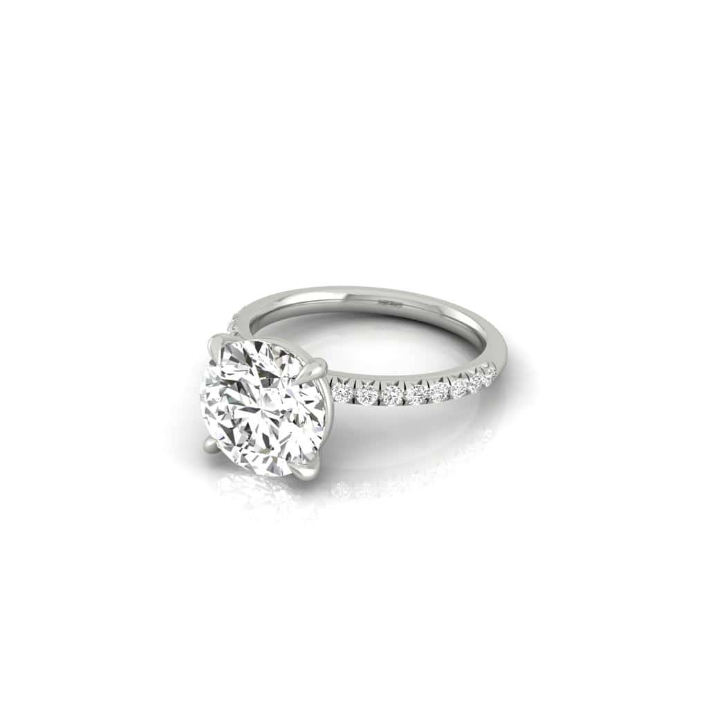 The Amélie engagement ring showcases a prong-set center diamond with a majestic sparkle, surrounded by smaller diamonds in a French Pavé style on the band, set against a neutral background.